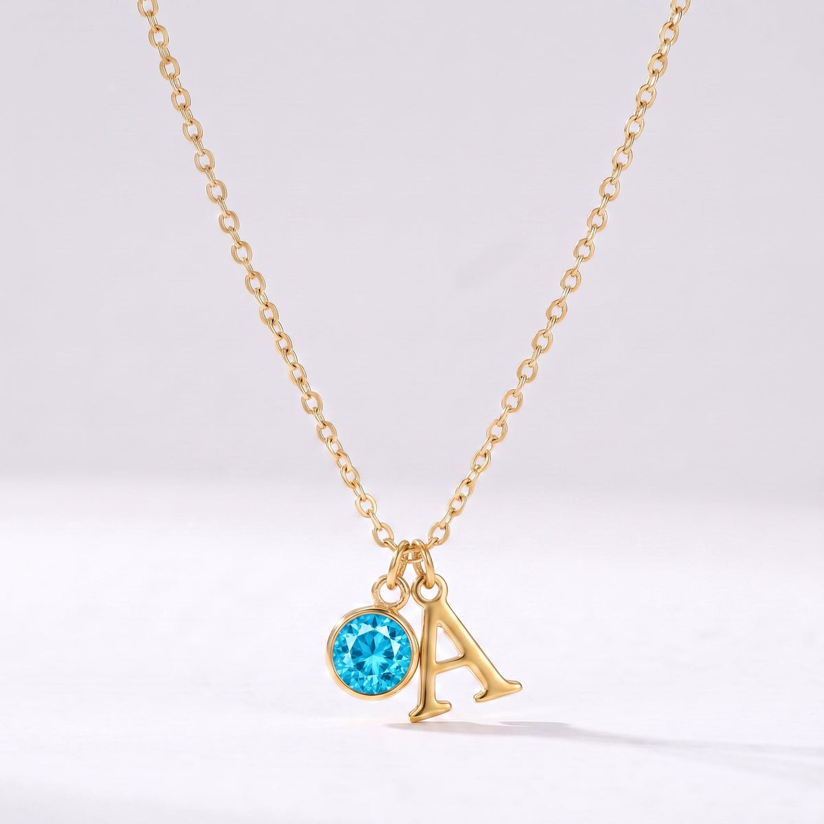 Collar letra A dorado con piedra de nacimiento Diciembre — Topacio azul
