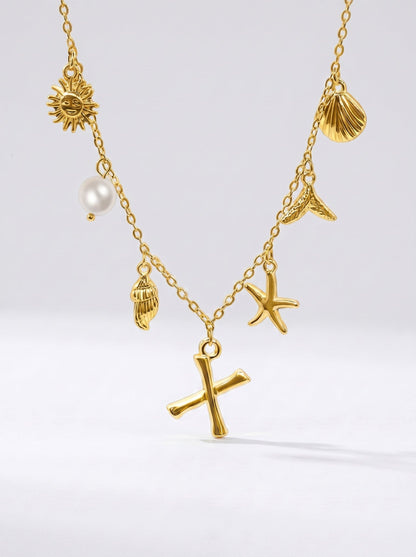 Collar dorado del mar con letra inicial X, estrella de mar, conchas, perla y colgante de sol.