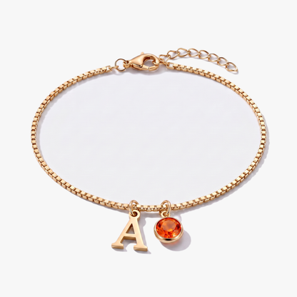 Pulsera letra A dorada con piedra de nacimiento Julio — Rubí