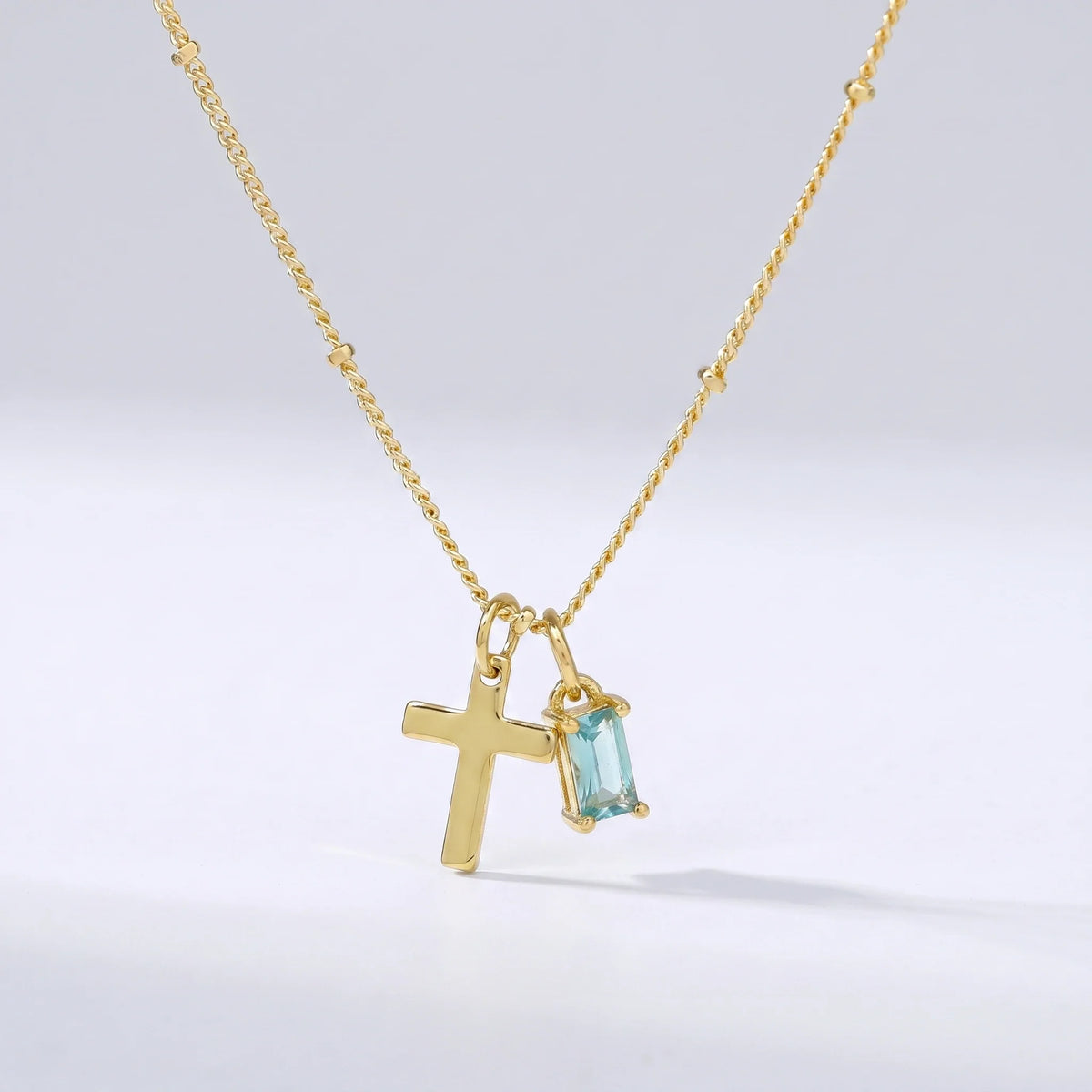 Collar cruz con piedra de nacimiento Diciembre — Topacio azul
