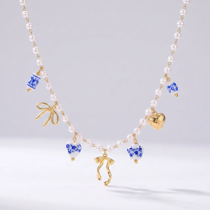 Collar de perlas con lazos dorados y cuentas de cerámica cerámica española