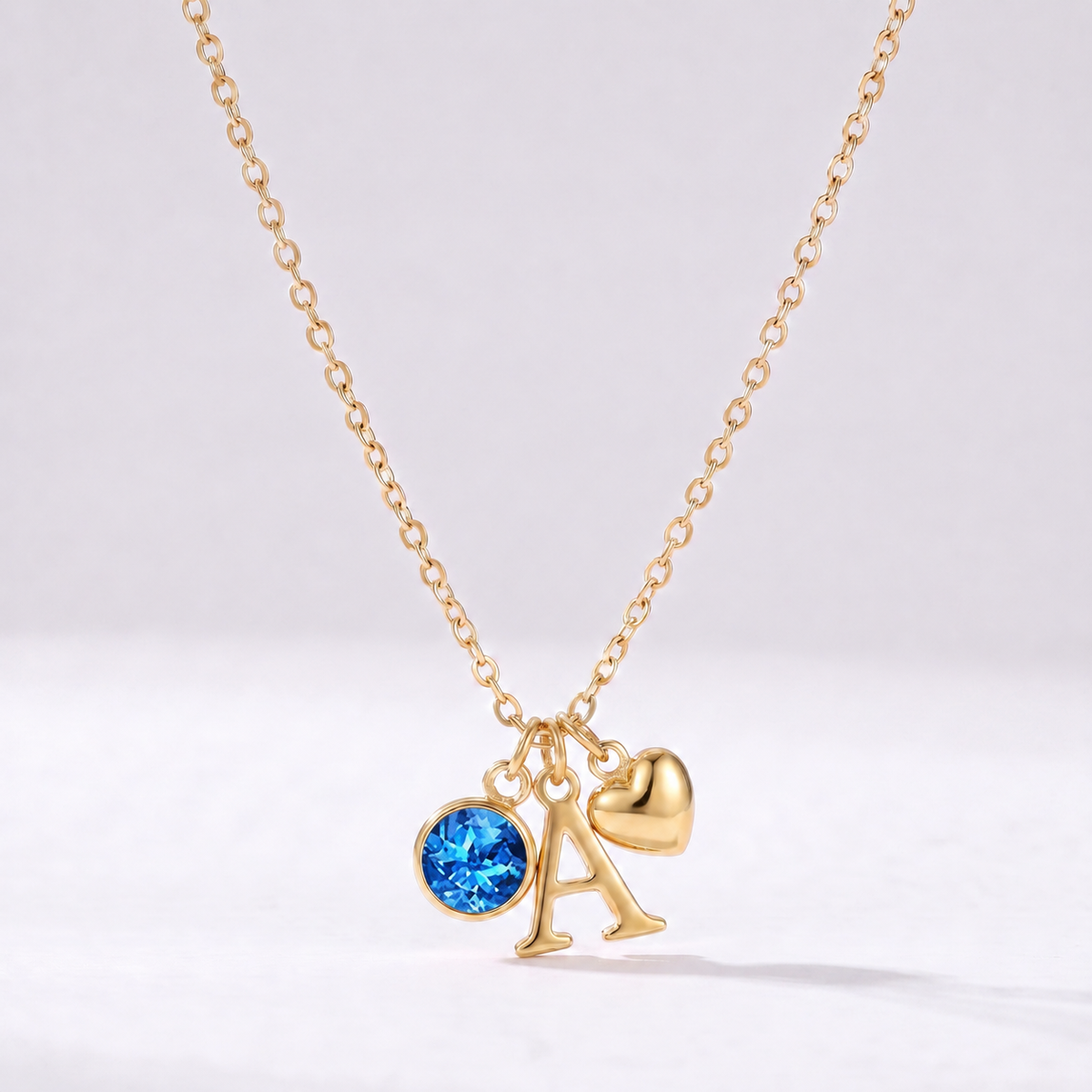 Collar letra A dorado con piedra de nacimiento Diciembre — Topacio azul y coração