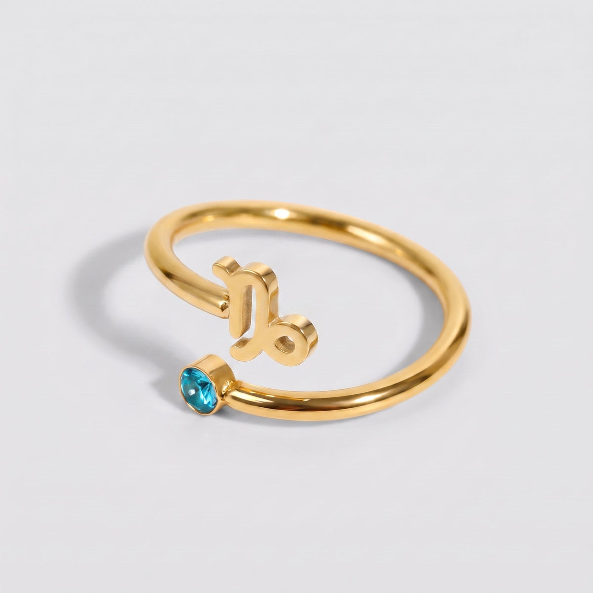 Anillo signo del zodiaco Capricornio dorado con piedra Topacio azul