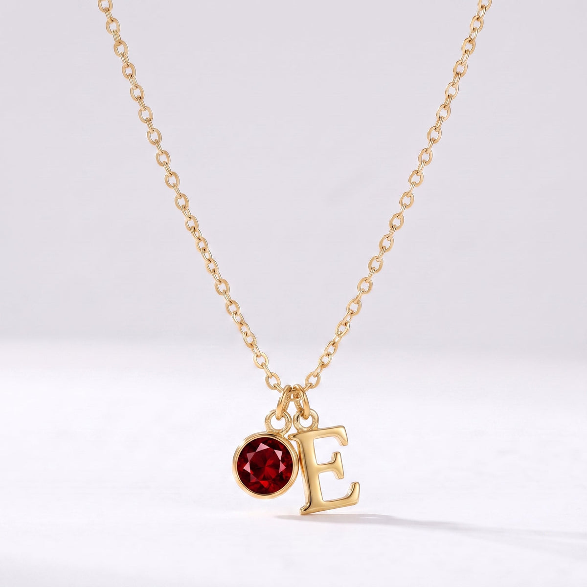 Collar letra E dorado con piedra de nacimiento