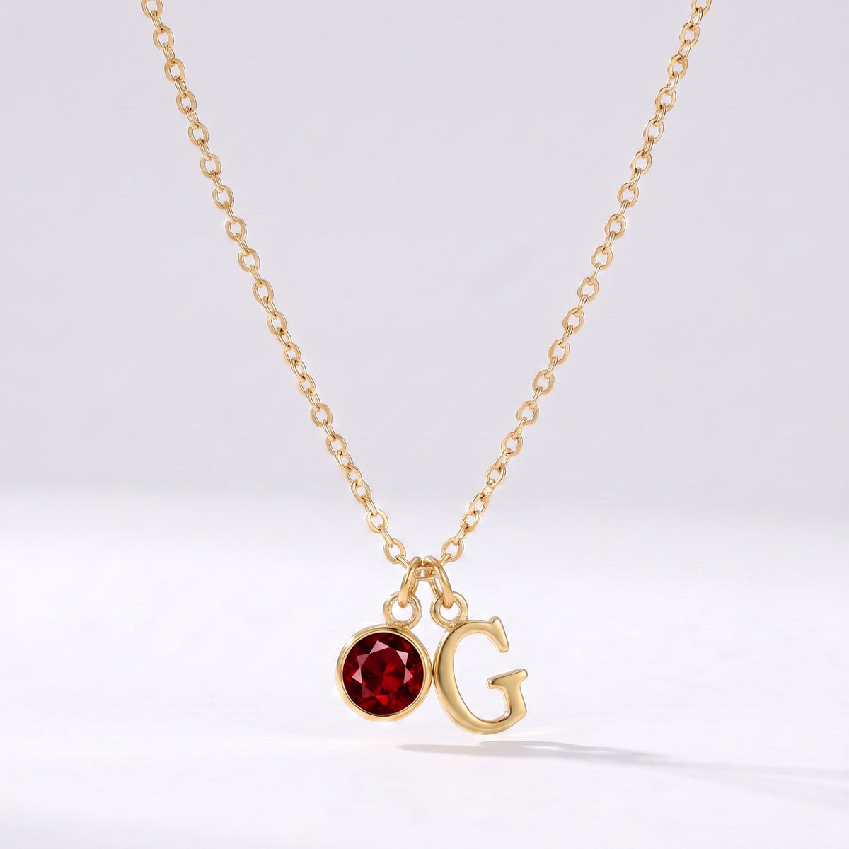 Collar letra G dorado con piedra de nacimiento