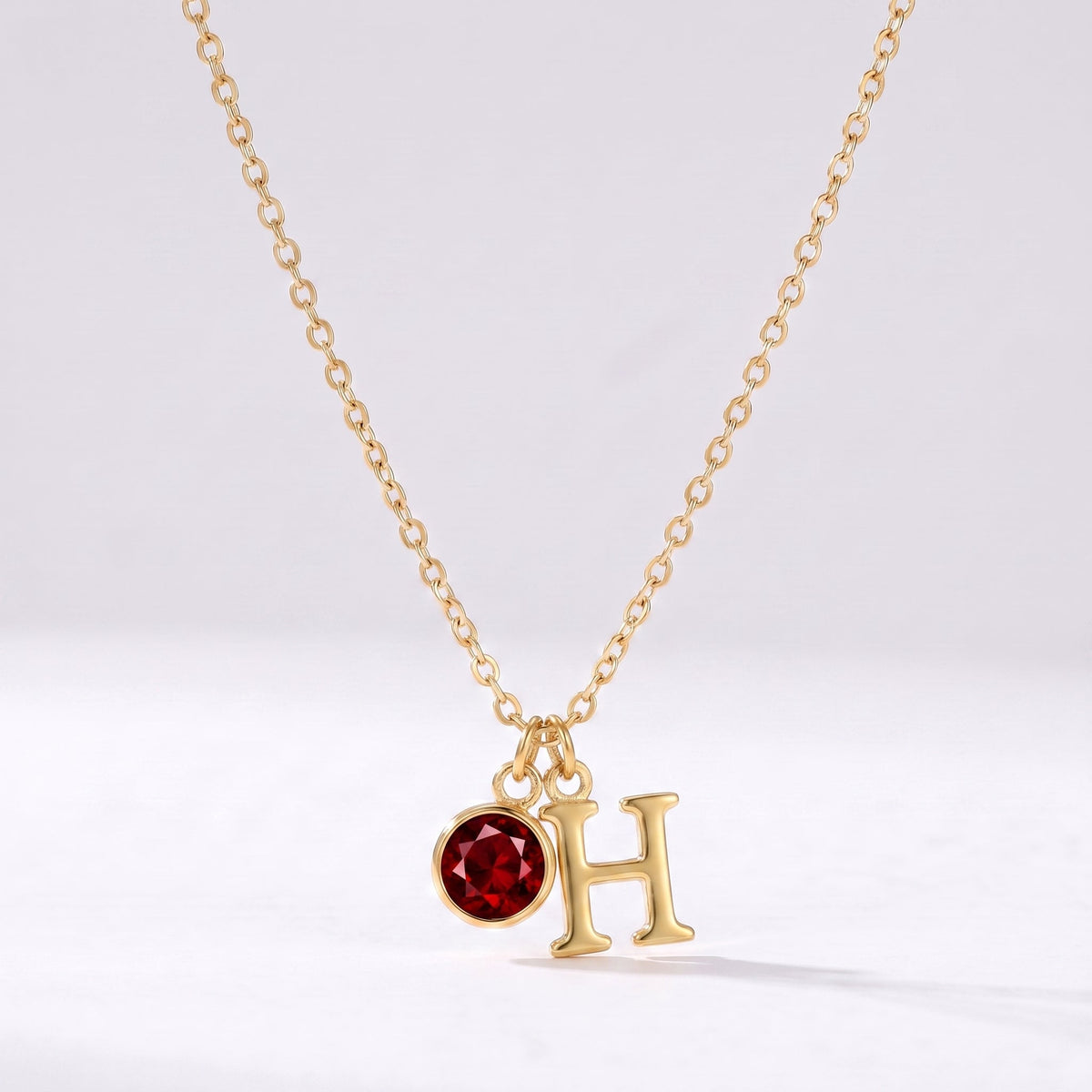 Collar letra H dorado con piedra de nacimiento