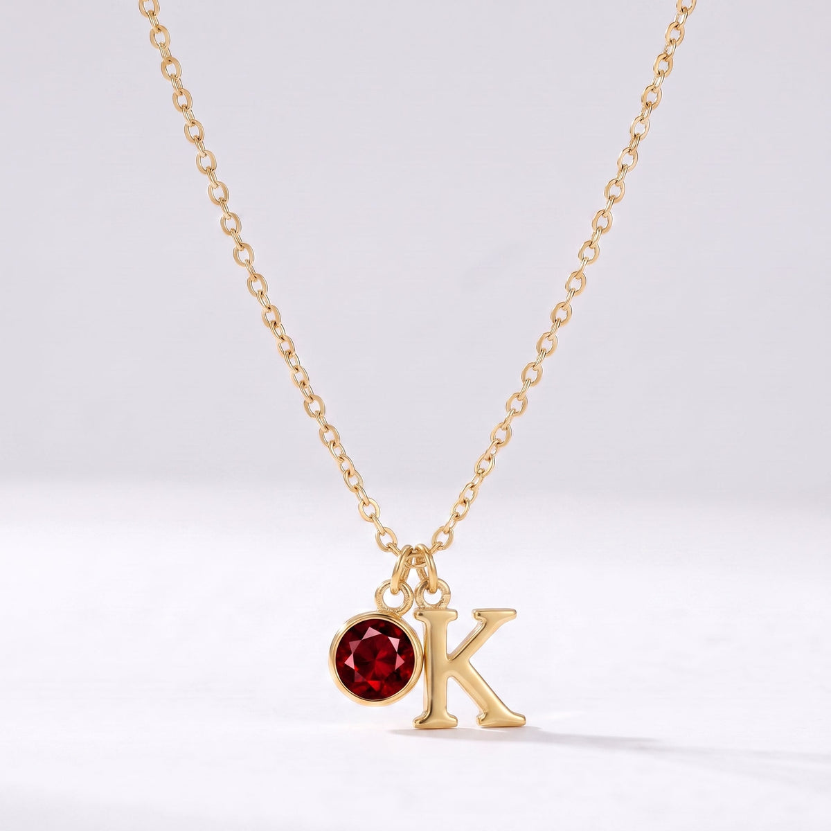 Collar letra K dorado con piedra de nacimiento