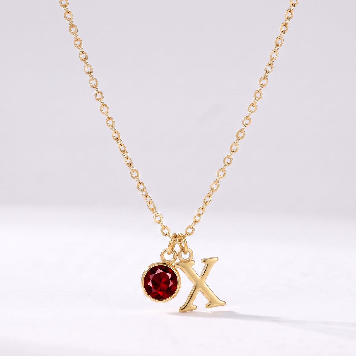 Collar letra X dorado con piedra de nacimiento