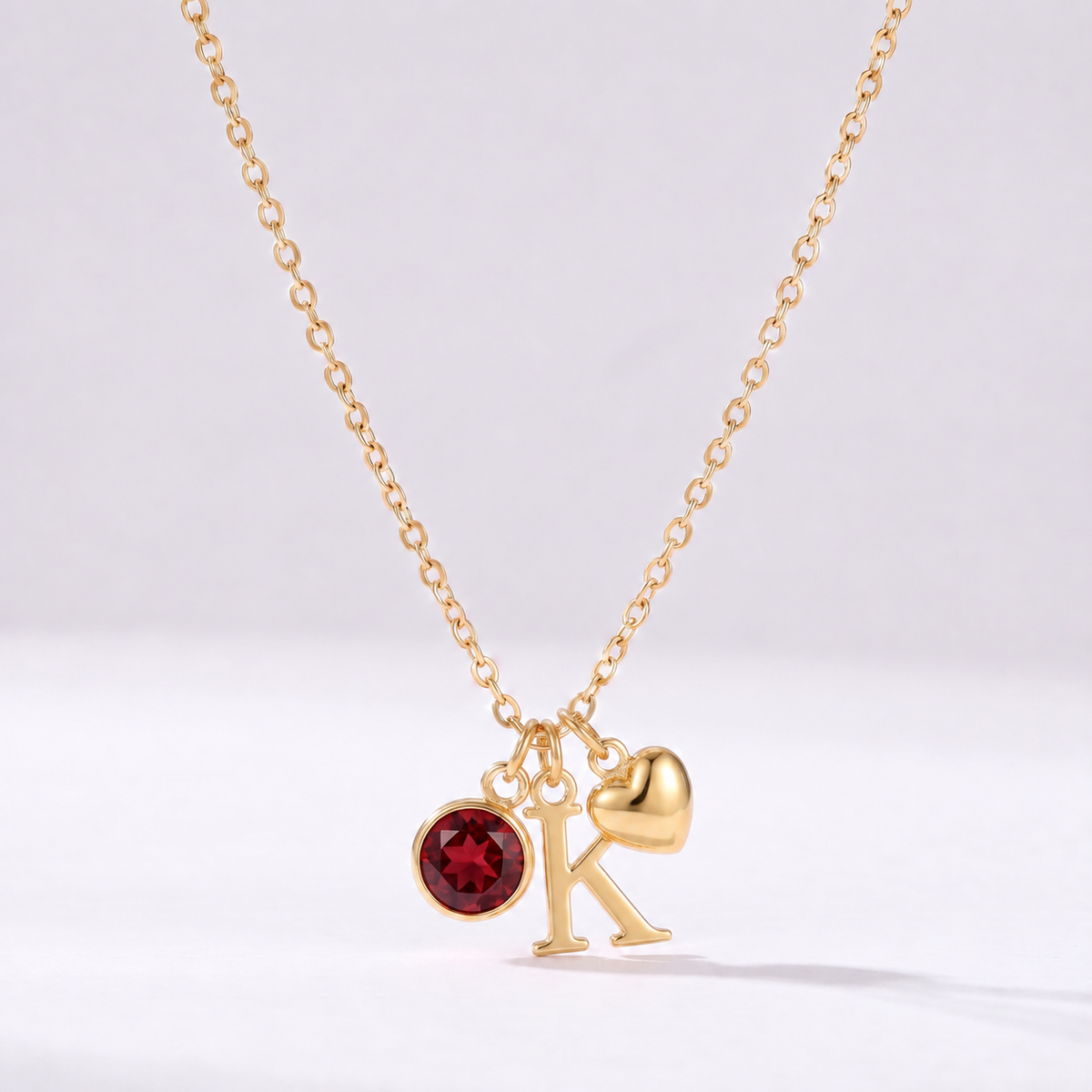 Collar letra K dorado con piedra de nacimiento y coração