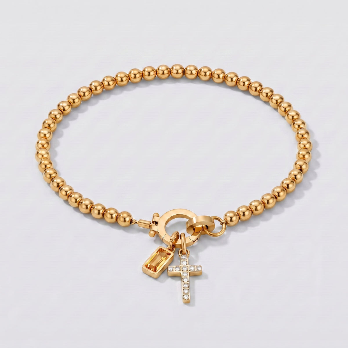 Pulsera plateada de cuentas con cruz y piedra de nacimiento citrino amarillo de noviembre.