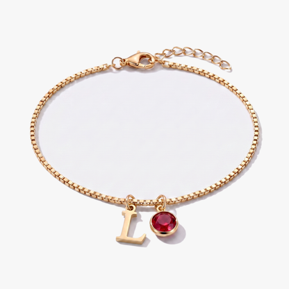 Pulsera letra L dorada con piedra de nacimiento Enero — Granate