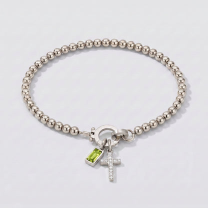 Pulsera plateada de cuentas con cruz y piedra de nacimiento peridoto verde de agosto.