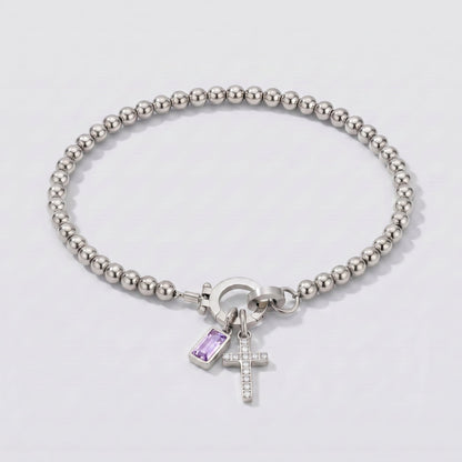 Pulsera plateada de cuentas con cruz y piedra de nacimiento alejandrita lila de junio.