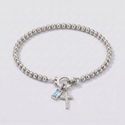 Pulsera plateada de cuentas con cruz y piedra de nacimiento aguamarina azul claro de marzo.
