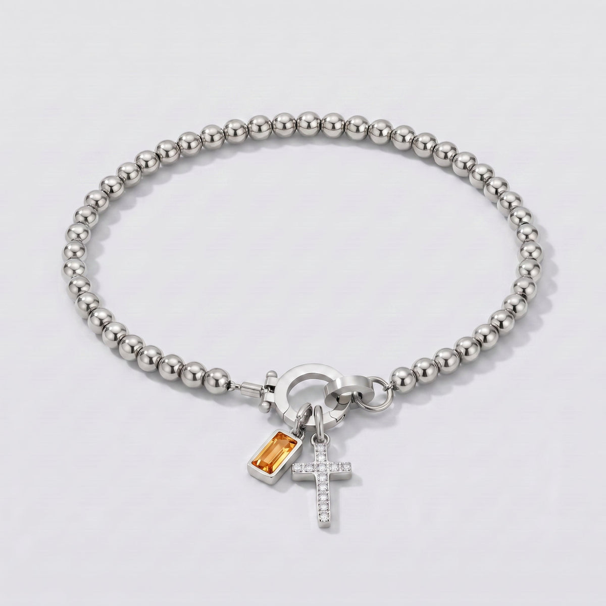 Pulsera plateada de cuentas con cruz y piedra de nacimiento citrino amarillo de noviembre.