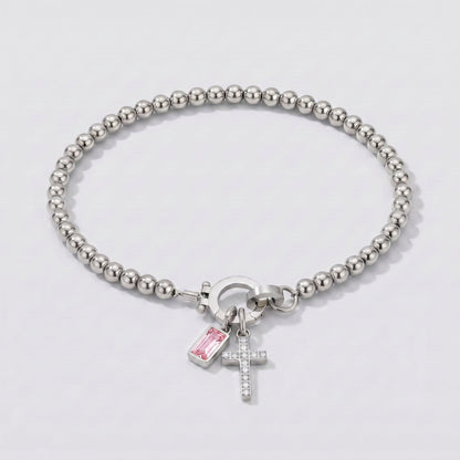 Pulsera plateada de cuentas con cruz y piedra de nacimiento turmalina rosa de octubre.